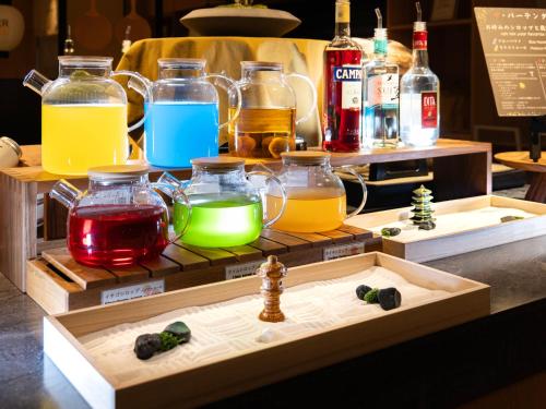 a display of different colored liquids in glass jars at Super Hotel Kyoto Shijokawaramachi in Kyoto