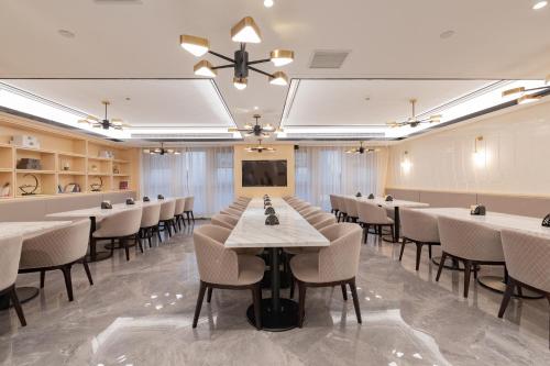 a banquet hall with tables and chairs and a projector at Atour Hotel (Suzhou Wujiang Wuyue Plaza) in Suzhou