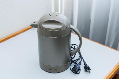 a coffee maker sitting on a table at ビジネスホテル寿屋 in Handa