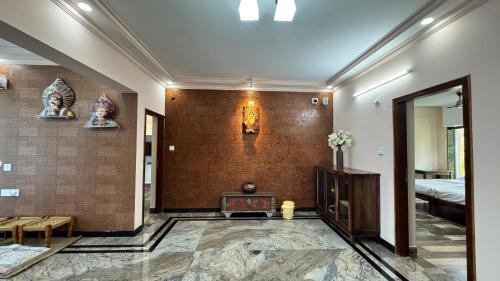 a living room with a fireplace and a bedroom at SUNSET SANDS Resort in Kundapur