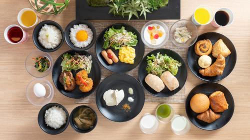a group of plates of food on a table at Super Hotel Kyoto Shijokawaramachi in Kyoto