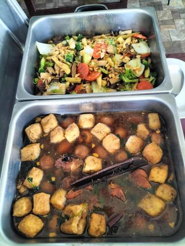 two trays of food with different types of food at Grandsiri Resort KhaoYai in Mu Si