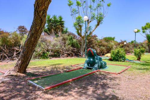 a small green elephant statue sitting on a grass field at Royal Suite Caesarea in Caesarea