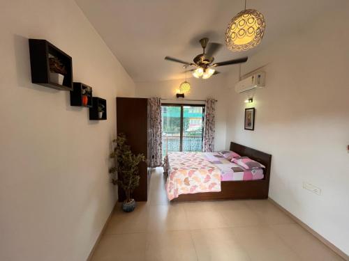 a bedroom with a bed and a ceiling fan at Royal Villa 1 - Luxurious 2BHK Villa with Huge Pvt Swimming Pool in Lonavala