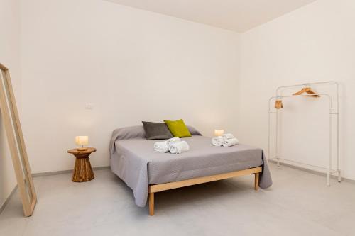 a bedroom with a bed with towels on it at Salenthea apartments in Melpignano