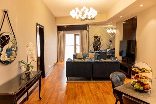 a living room with a couch and a table at Majestic City Retreat Hotel in Dubai