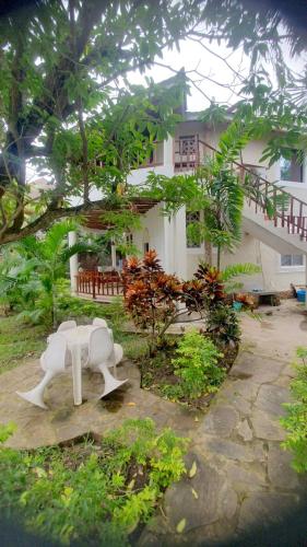 a white bench in front of a house at Manuastro Breeze Villa in Galu