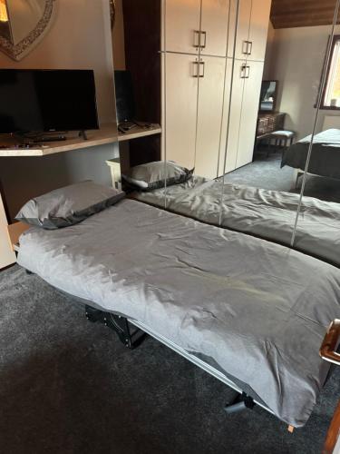 a bed in a room with a mirror at Beech barn in Standish