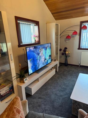 a living room with a large flat screen tv at Beech barn in Standish