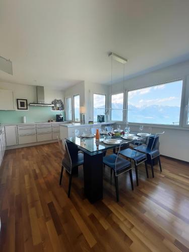 a kitchen and dining room with a table and chairs at Panoramic Holiday Villa in Montreux in Montreux