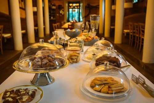 a table with several plates of food in glass containers at Agriturismo Trerè in Faenza
