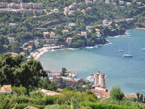 a view of a beach with a boat in the water at Modern Villa with Pool in Montauroux France in Montauroux