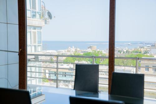 an office with a view of the city from a window at Sunday Hotel & Apartments in Baku