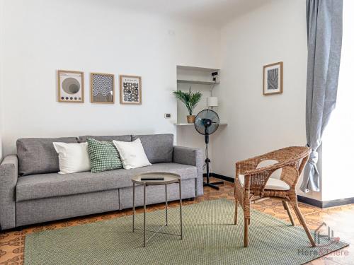 a living room with a gray couch and a chair at Garden Paradise - Free Parking - Terminal 4min in Savona