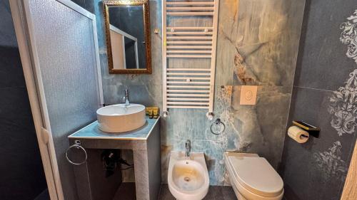 a bathroom with a sink and a toilet at B&B Antenna 2 by Ca-Sa Check in Chioggia