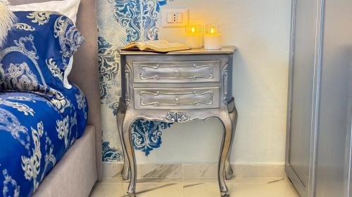 a nightstand with a book on it next to a bed at B&B Antenna 2 by Ca-Sa Check in Chioggia