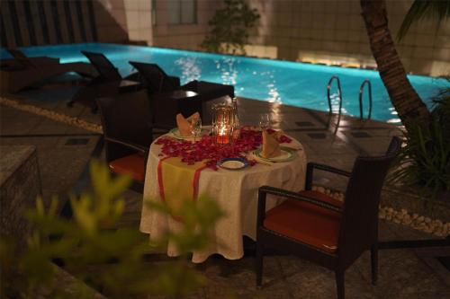 a table with a white table cloth and flowers on it at Radisson Blu Hotel, Nagpur in Nagpur