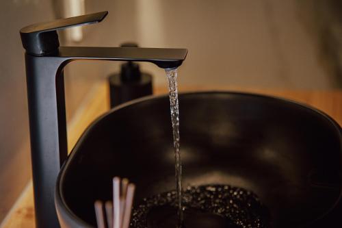 a stream of water being poured into a pot at Mielno Residence in Mielno