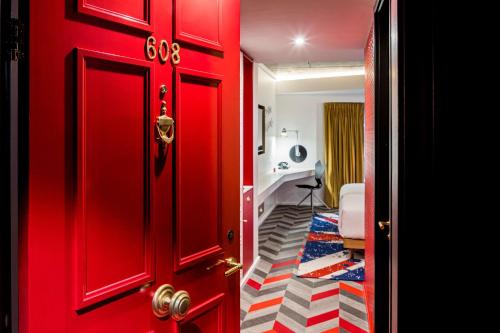 a red door leading to a room with a red floor at nhow London in London