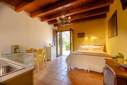 a bedroom with a bed and a kitchen with a sink at Il Laghello Wood House in Framura