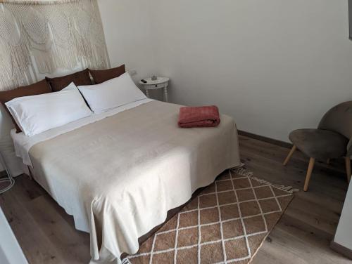 a bedroom with a bed with a red towel on it at Dimora Tauro B&B in Fasano