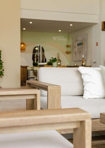 a living room with a couch and two wooden benches at Soul Spring Sanctuary Cuernavaca in Xochitepec