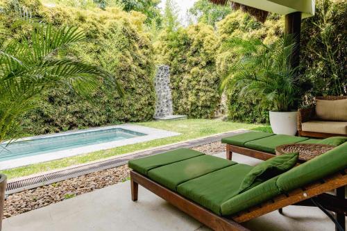 a patio with a couch and a swimming pool at Soul Spring Sanctuary Cuernavaca in Xochitepec