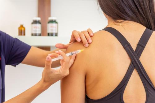 a woman getting her arm vaccinated with a thermometer at Soul Spring Sanctuary Cuernavaca in Xochitepec