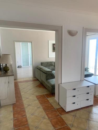 a living room with a couch and a table at un site calme et unique au Montenegro Loue des logements les pieds dans l eau avec plage privée en face de l ile Saint Marco in Tivat