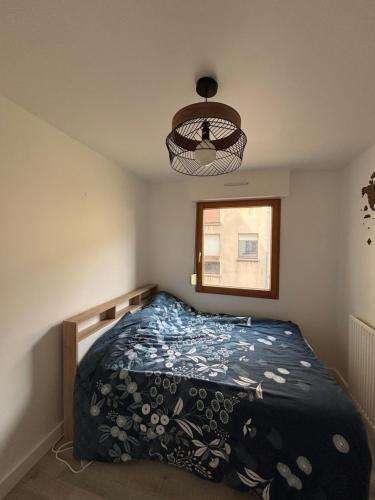 une chambre avec un lit avec une couette bleue dans l'établissement Appartement cosy à Cherbourg!, à Cherbourg en Cotentin