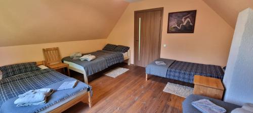 a room with two beds and a table and a chair at Kalnāres 