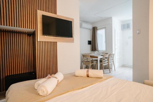 a bedroom with a bed with a tv on the wall at Como Charm Living Apartment Duomo in Como