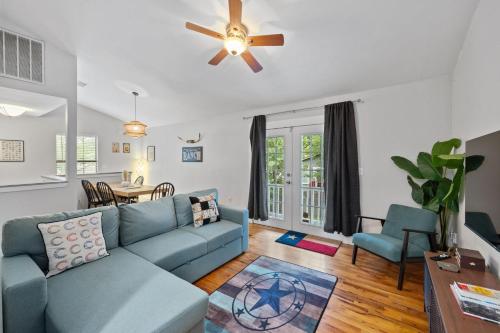 a living room with a blue couch and a table at 4BR house in trendy East Austin in Austin