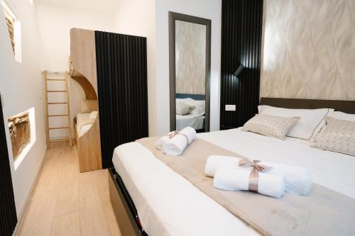 a bedroom with a bed with towels on it at Como Charm Living Apartment Duomo in Como