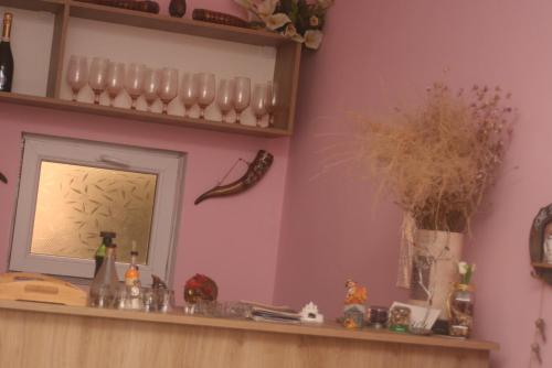 a room with a mirror and a shelf with glassases at Hotel Rabati in Akhaltsikhe