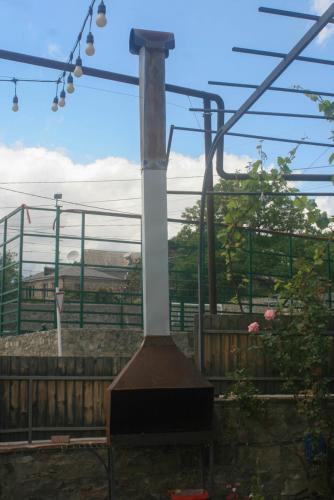 a large stove in a garden with a view at Hotel Rabati in Akhaltsikhe