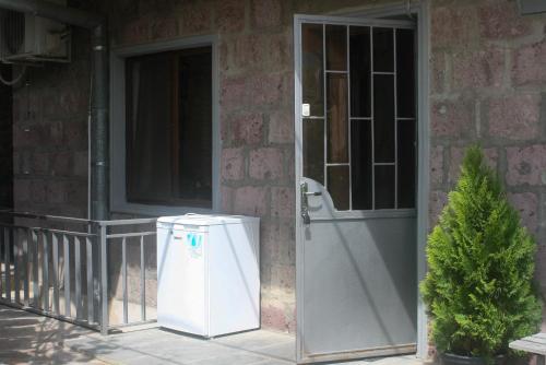 a door to a house with a trash can next to it at Hotel Rabati in Akhaltsikhe
