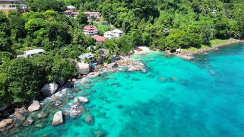 an aerial view of a river with turquoise water at Marquise & Infinity villas in Glacis