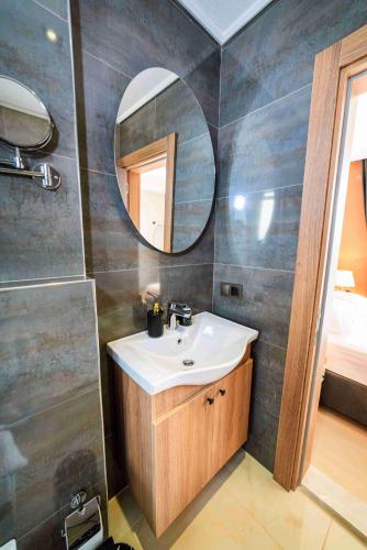 a bathroom with a sink and a mirror at Villa Meyra in Kaş