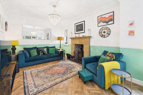 a living room with two blue couches and a fireplace at Host & Stay - Church Lane in Nunthorpe