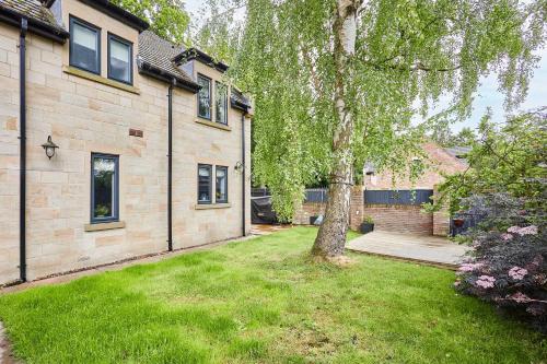 a house with a tree in the yard at Host & Stay - Church Lane in Nunthorpe