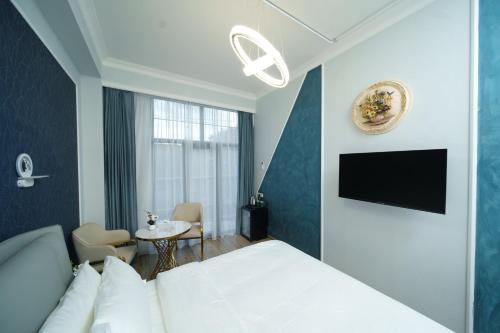 a hotel room with a bed and a table at Emmanuel Hotel Yerevan in Yerevan
