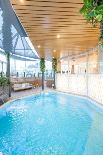 a large swimming pool in a building at Mercure Grenoble Centre Porte des Alpes in Grenoble