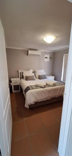 a bedroom with two beds and two night stands at Firehouse selfcatering Garden Cottages no 5 in Wellington