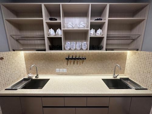 a kitchen with two sinks and shelves with shoes at STARS University Dormitory in Tashkent