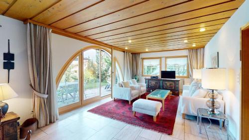 a bedroom with a bed and a living room at Greina in Celerina