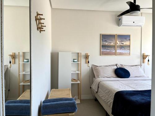 a bedroom with a bed and a mirror at Apartment by the sea Torres Parque da Guarita in Torres