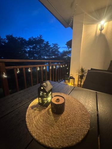 a table with two candles on top of a deck at Marena Studio - Santa Marina, Sozopol in Sozopol