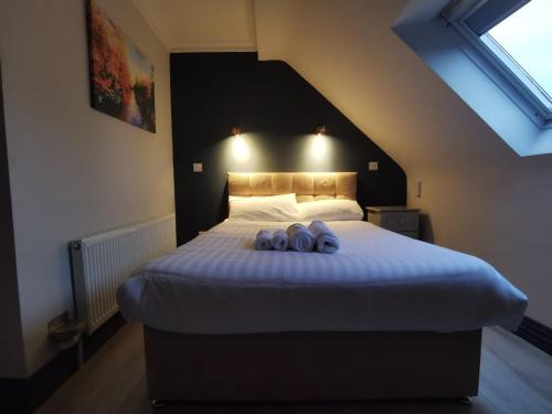 a bedroom with a bed with two pairs of shoes on it at N20 Inn Hotel in Mallow