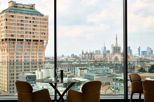 a view of the city from a room with windows at Uptown Palace in Milan